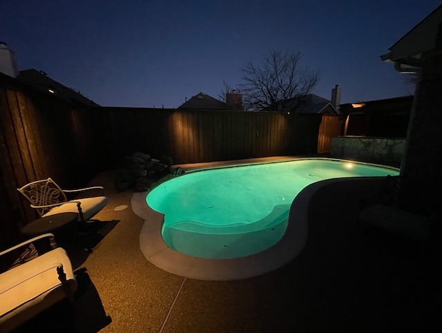 2433 Mallard Dr, Little Elm, TX 75068 - pool at night with a fenced backyard and a patio area
