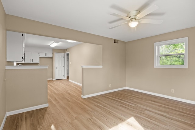 310 Reynolds, Pittsburg, TX 75686 - unfurnished living room with light wood-type flooring, baseboards, and a ceiling fan