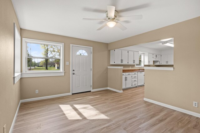 310 Reynolds, Pittsburg, TX 75686 - entryway featuring light wood-type flooring, ceiling fan, and baseboards