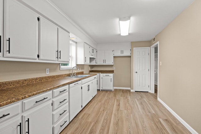 310 Reynolds, Pittsburg, TX 75686 - kitchen with a sink, light wood-type flooring, white dishwasher, white cabinetry, and baseboards