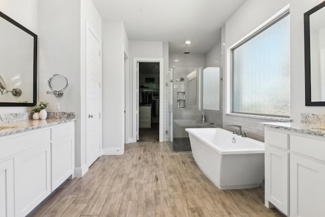 424 Trigger Trl, Argyle, TX 76226 - full bath featuring a stall shower, vanity, a freestanding bath, and wood finished floors