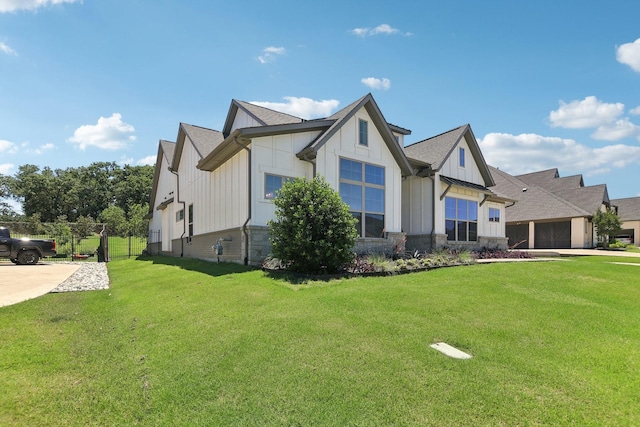 424 Trigger Trl, Argyle, TX 76226 - view of front of house featuring board and batten siding, a front lawn, an attached garage, stone siding, and concrete driveway