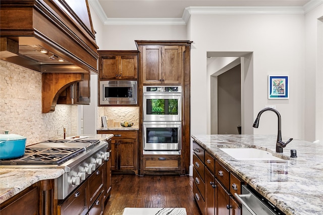 655 Creekway Dr, Irving, TX 75039 - kitchen featuring appliances with stainless steel finishes, a sink, dark wood-style flooring, light stone counters, and backsplash