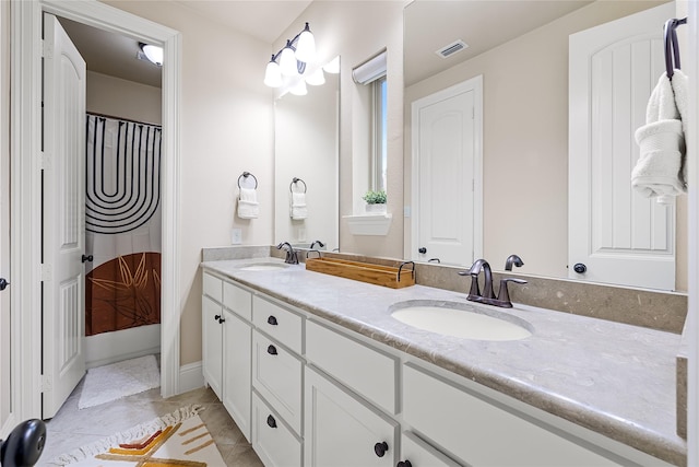 655 Creekway Dr, Irving, TX 75039 - bathroom featuring double vanity and tile patterned floors