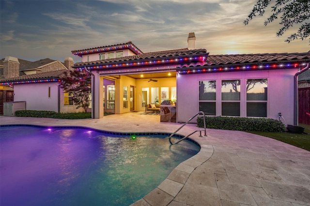655 Creekway Dr, Irving, TX 75039 - rear view of property with a tile roof, a patio area, an outdoor pool, stucco siding, and a chimney