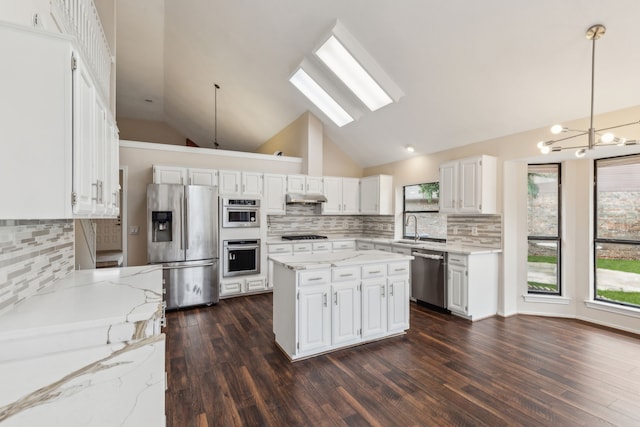 4103 Bendwood Ln, Dallas, TX 75287 - kitchen with stainless steel appliances, a sink, decorative backsplash, a skylight, and high vaulted ceiling