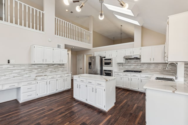 4103 Bendwood Ln, Dallas, TX 75287 - kitchen featuring a sink, stainless steel appliances, a skylight, under cabinet range hood, and tasteful backsplash