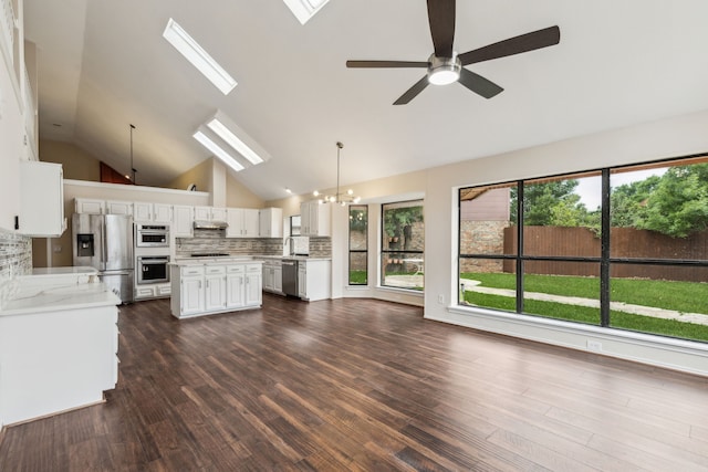 4103 Bendwood Ln, Dallas, TX 75287 - kitchen with appliances with stainless steel finishes, a ceiling fan, light countertops, a chandelier, and backsplash