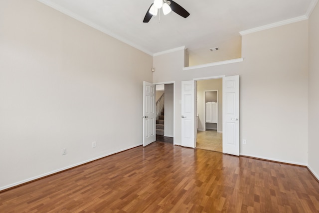 4103 Bendwood Ln, Dallas, TX 75287 - unfurnished bedroom featuring wood finished floors, baseboards, ornamental molding, a ceiling fan, and a towering ceiling