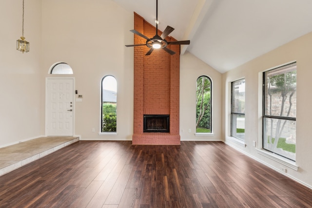 4103 Bendwood Ln, Dallas, TX 75287 - unfurnished living room featuring high vaulted ceiling, a brick fireplace, a ceiling fan, dark wood-type flooring, and healthy amount of natural light