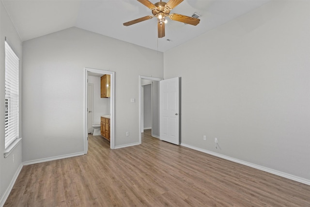 1039 Spring Hill Dr, Saginaw, TX 76179 - unfurnished bedroom with light wood-style flooring, lofted ceiling, ceiling fan, and ensuite bathroom