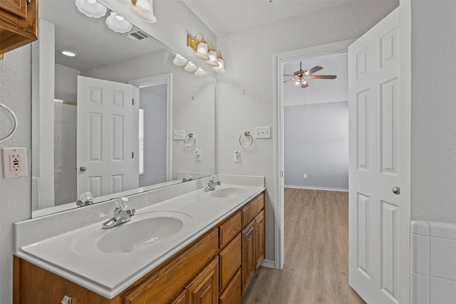 1039 Spring Hill Dr, Saginaw, TX 76179 - bathroom featuring double vanity, wood finished floors, and a ceiling fan
