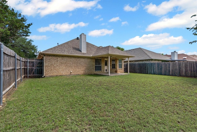 1039 Spring Hill Dr, Saginaw, TX 76179 - back of house with brick siding, a fenced backyard, a patio area, and a chimney