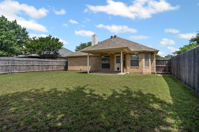 1039 Spring Hill Dr, Saginaw, TX 76179 - back of property featuring a patio, brick siding, a fenced backyard, a chimney, and a ceiling fan