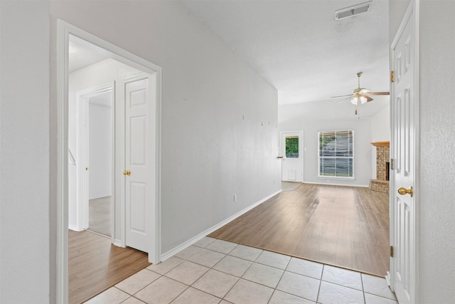 1039 Spring Hill Dr, Saginaw, TX 76179 - empty room featuring ceiling fan, light wood-style flooring, and a brick fireplace