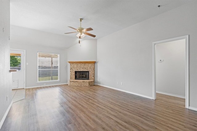 1039 Spring Hill Dr, Saginaw, TX 76179 - unfurnished living room featuring ceiling fan, wood finished floors, a fireplace, and lofted ceiling