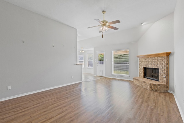 1039 Spring Hill Dr, Saginaw, TX 76179 - unfurnished living room featuring a ceiling fan, wood finished floors, a brick fireplace, and vaulted ceiling