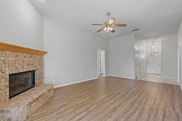 1039 Spring Hill Dr, Saginaw, TX 76179 - unfurnished living room featuring wood finished floors, ceiling fan, and a fireplace