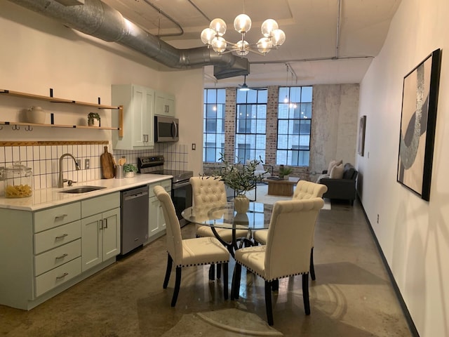 1122 Jackson St Unit 416, Dallas, TX 75202 - dining area featuring concrete floors, baseboards, and a chandelier