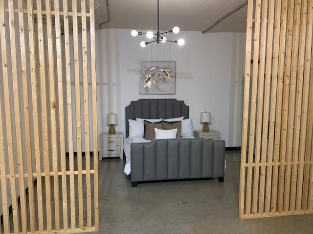 1122 Jackson St Unit 416, Dallas, TX 75202 - bedroom featuring finished concrete floors and a chandelier