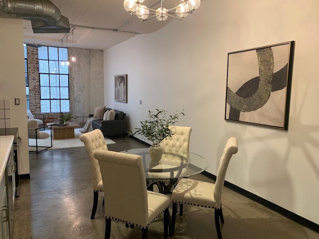 1122 Jackson St Unit 416, Dallas, TX 75202 - dining room with finished concrete flooring, a chandelier, and baseboards