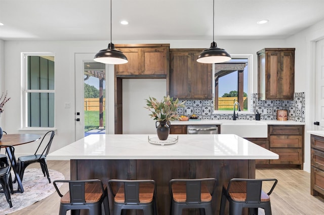416 Redbud Ln, Tolar, TX 76476 - kitchen with a sink, light countertops, healthy amount of natural light, tasteful backsplash, and recessed lighting