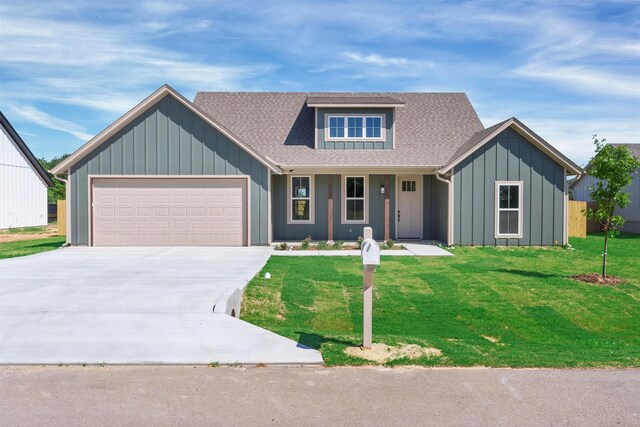 416 Redbud Ln, Tolar, TX 76476 - view of front of house featuring board and batten siding, driveway, a garage, and a front lawn