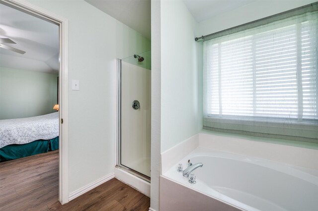 9912 Fillmore Dr, Mckinney, TX 75072 - ensuite bathroom featuring a stall shower, wood finished floors, a garden tub, ceiling fan, and baseboards