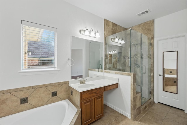 2410 Honey Dr, Arlington, TX 76001 - full bath featuring a bath, a shower stall, tile patterned floors, and vanity
