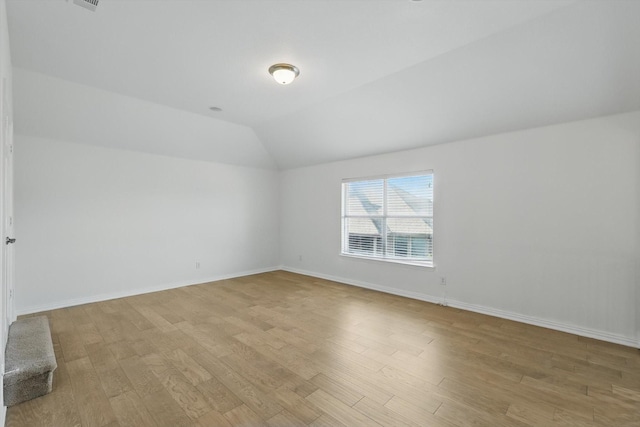 2410 Honey Dr, Arlington, TX 76001 - empty room featuring light wood-type flooring and vaulted ceiling