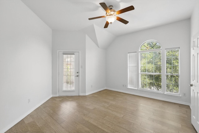 2410 Honey Dr, Arlington, TX 76001 - spare room featuring plenty of natural light, ceiling fan, light wood-style flooring, and lofted ceiling