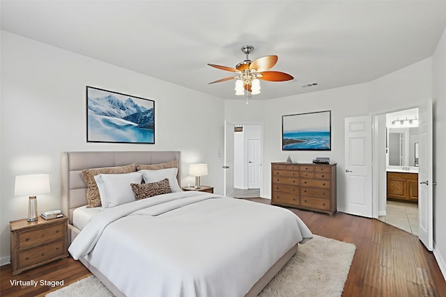 2410 Honey Dr, Arlington, TX 76001 - bedroom featuring hardwood / wood-style flooring, ensuite bathroom, and a ceiling fan