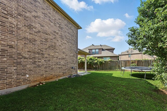 2410 Honey Dr, Arlington, TX 76001 - fenced yard featuring a trampoline