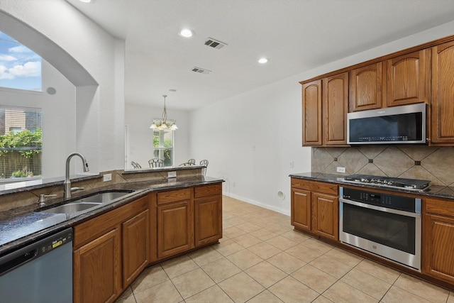 2410 Honey Dr, Arlington, TX 76001 - kitchen featuring stainless steel appliances, backsplash, dark stone counters, recessed lighting, and light tile patterned floors