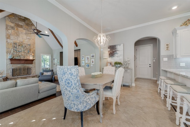 105 Orion Ct, Aurora, TX 76078 - dining room featuring arched walkways, ceiling fan, crown molding, a chandelier, and lofted ceiling