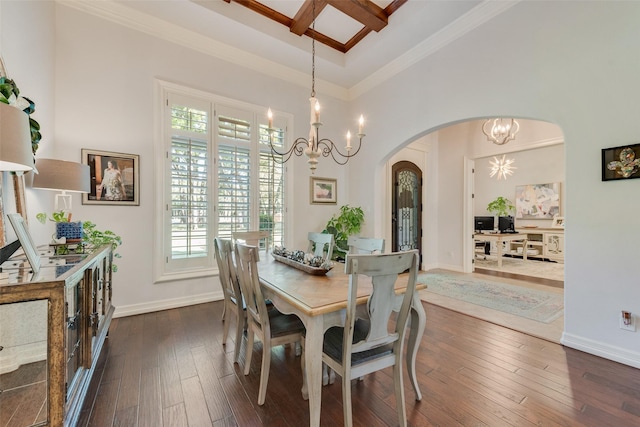 105 Orion Ct, Aurora, TX 76078 - dining area featuring arched walkways, a chandelier, crown molding, dark wood-style floors, and baseboards