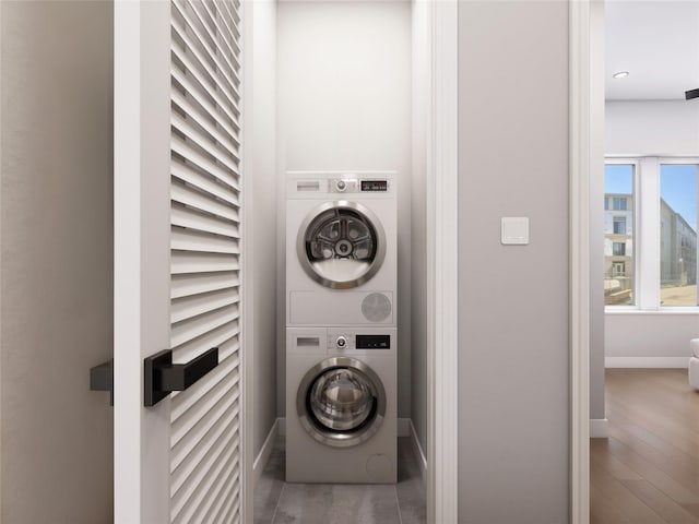 815 E 5th St, Dallas, TX 75203 - washroom with stacked washing machine and dryer, baseboards, wood finished floors, and recessed lighting