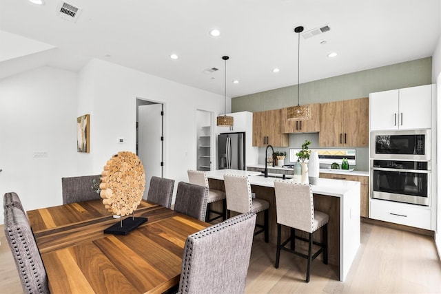 815 E 5th St, Dallas, TX 75203 - dining area with light wood-style floors and recessed lighting