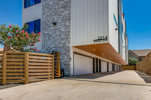 2214 Annex Ave Unit 106, Dallas, TX 75204 - view of property with an attached garage and concrete driveway