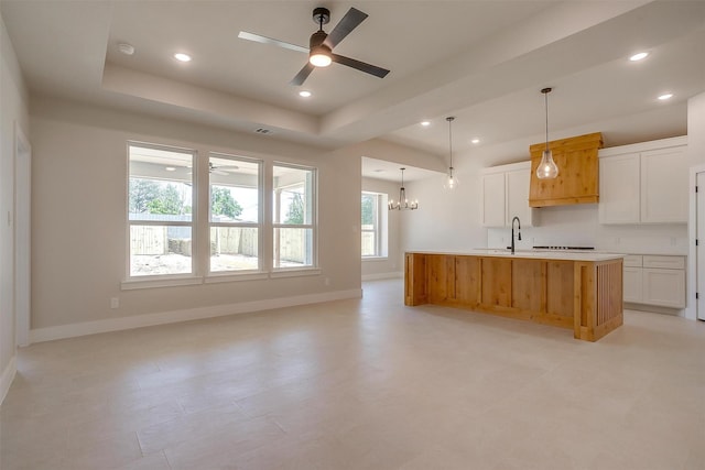 2602 23rd St, Fort Worth, TX 76106 - kitchen with ceiling fan, a tray ceiling, light countertops, white cabinets, and recessed lighting