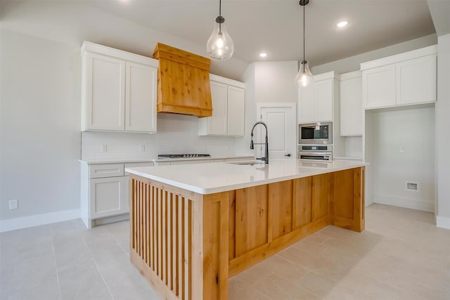 2602 23rd St, Fort Worth, TX 76106 - kitchen featuring stainless steel appliances, a sink, backsplash, an island with sink, and white cabinets