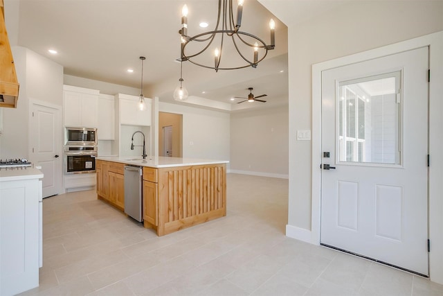 2602 23rd St, Fort Worth, TX 76106 - kitchen featuring appliances with stainless steel finishes, a sink, light countertops, a ceiling fan, and a chandelier