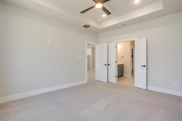 2602 23rd St, Fort Worth, TX 76106 - unfurnished bedroom featuring light colored carpet, a tray ceiling, recessed lighting, baseboards, and ensuite bathroom
