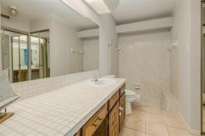 14151 Montfort Dr Unit 201, Dallas, TX 75254 - full bath featuring toilet, a shower, tile patterned floors, and vanity