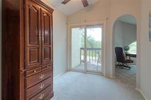 14151 Montfort Dr Unit 201, Dallas, TX 75254 - bedroom featuring access to exterior, lofted ceiling, arched walkways, carpet floors, and baseboards