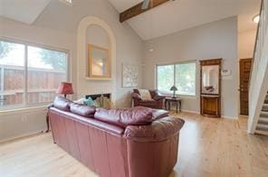 14151 Montfort Dr Unit 201, Dallas, TX 75254 - living room with light wood finished floors, beamed ceiling, stairway, baseboards, and high vaulted ceiling