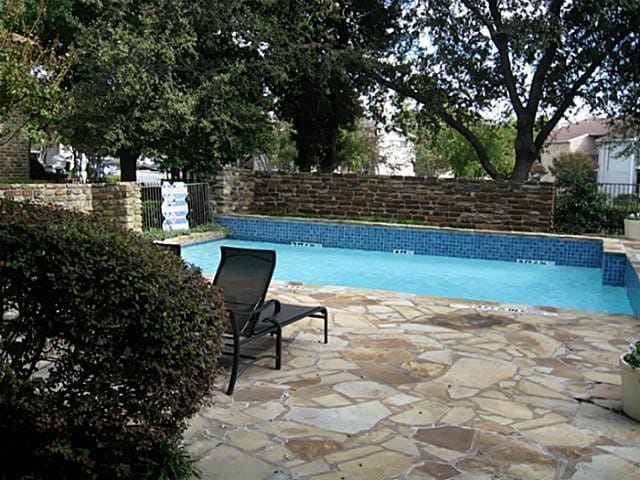 14151 Montfort Dr Unit 201, Dallas, TX 75254 - view of swimming pool with a fenced backyard and a patio