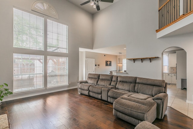 5424 Yellow Birch Dr, Fort Worth, TX 76244 - living room with a high ceiling, arched walkways, a ceiling fan, baseboards, and hardwood / wood-style floors