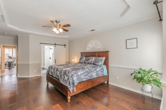 5424 Yellow Birch Dr, Fort Worth, TX 76244 - bedroom with a tray ceiling, a barn door, hardwood / wood-style flooring, baseboards, and ornamental molding