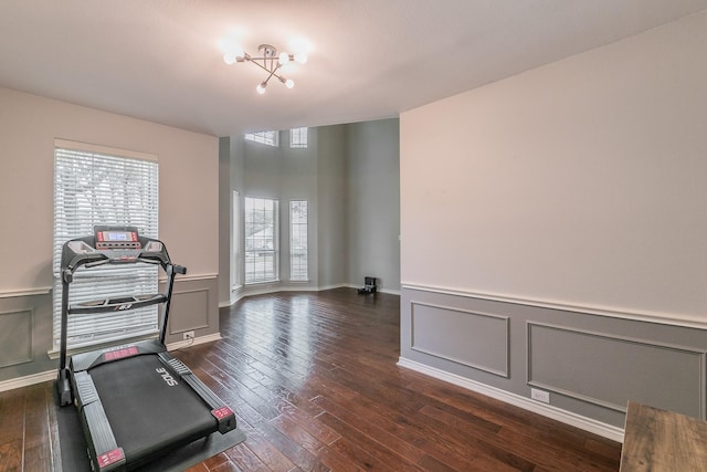 5424 Yellow Birch Dr, Fort Worth, TX 76244 - workout room with dark wood-style flooring, a wainscoted wall, a decorative wall, and a chandelier